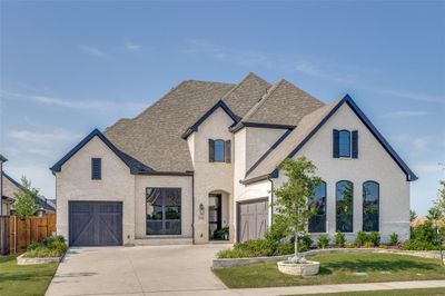 Modern transitional with white brick, black windows and j swing 3 car garage | Image 1