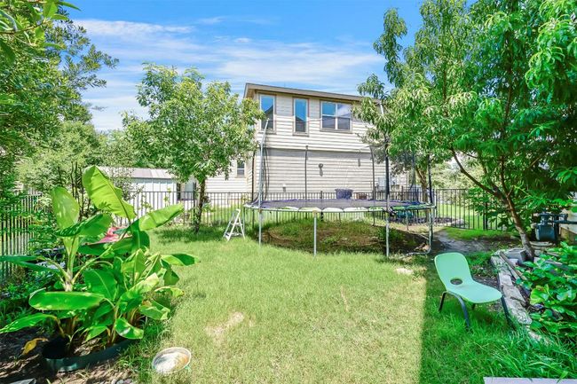 Back of house featuring a trampoline and a fenced backyard | Image 28