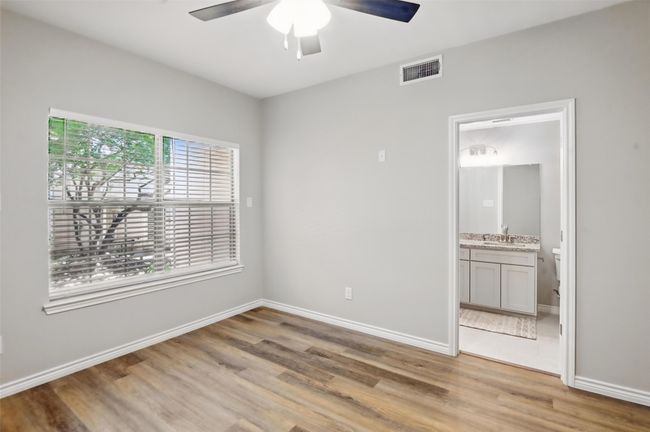 Unfurnished bedroom featuring light wood-style floors, visible vents, baseboards, and a sink | Image 14