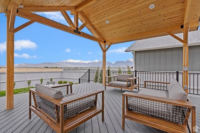Wooden terrace with fence, an outdoor living space, and a mountain view | Image 35