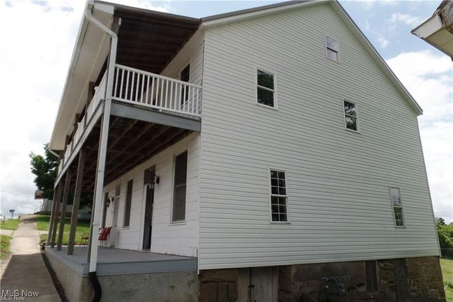 View of side of home featuring covered porch and a balcony | Image 15