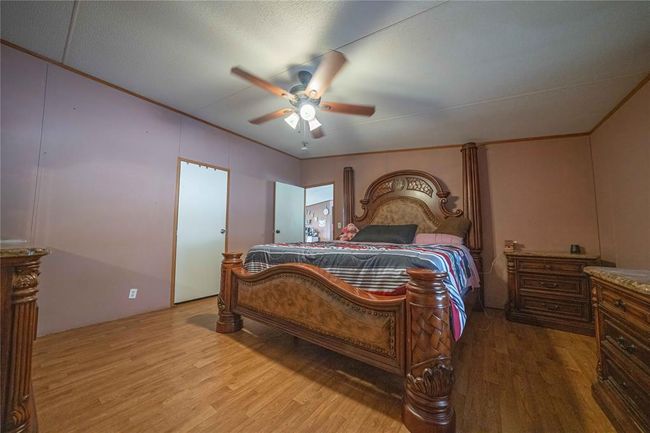 Bedroom featuring ceiling fan and light hardwood / wood-style flooring | Image 17