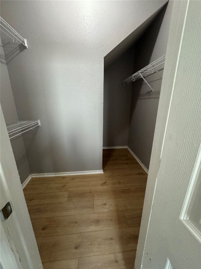 Walk in closet with wood-type flooring | Image 18