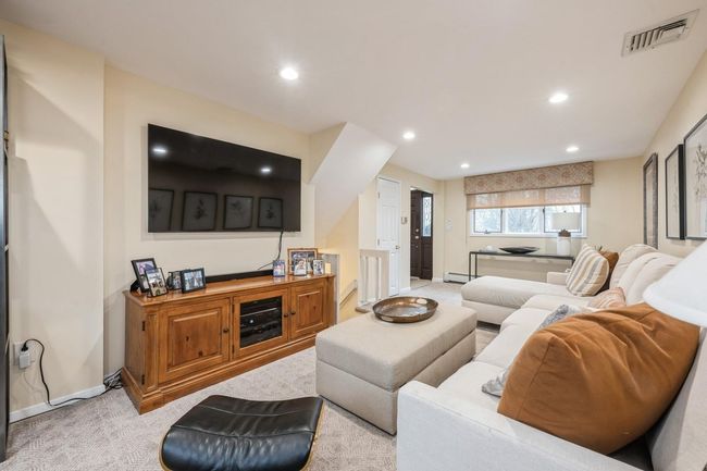 Living area with baseboards, light colored carpet, visible vents, a baseboard heating unit, and recessed lighting | Image 20