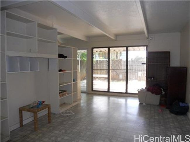 Living room with built in book cases and shelves. | Image 1