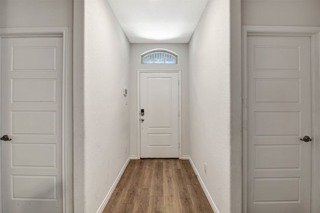 Doorway to outside with light wood-style flooring and baseboards | Image 13