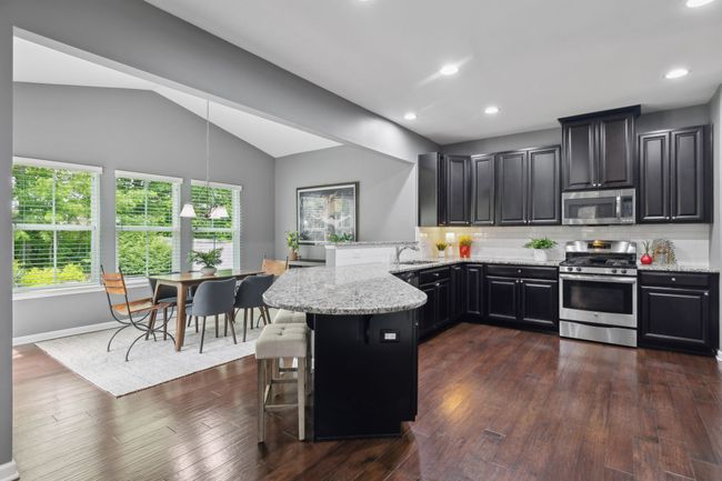 The spacious kitchen has plenty of workspace and plenty of storage. | Image 8