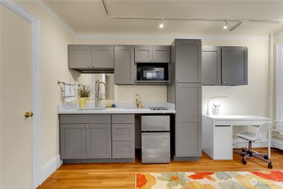 Fresh kitchenette with fridge, microwave and cooktop. | Image 2