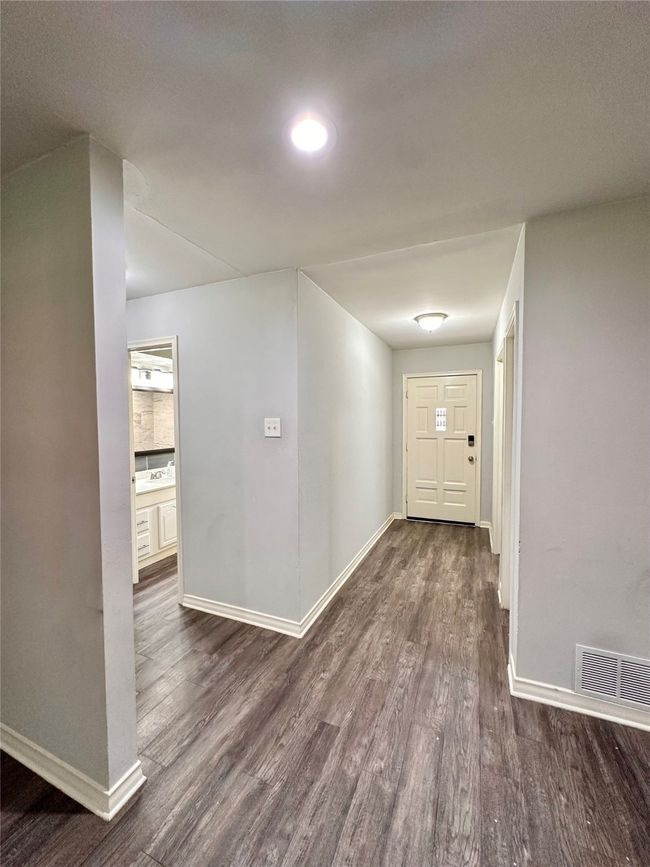 Foyer entrance with dark wood-style floors and baseboards | Image 6