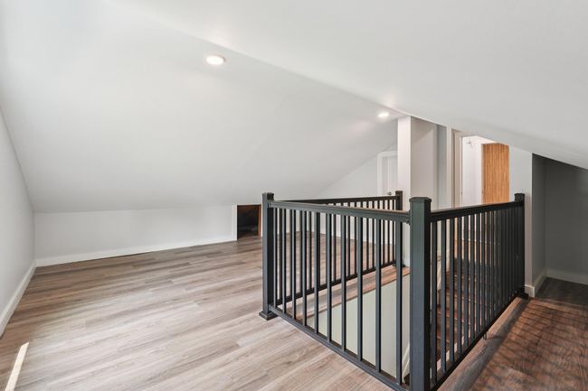 Additional living space featuring vaulted ceiling, wood finished floors, and recessed lighting | Image 25