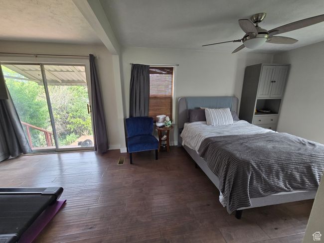 Bedroom featuring hardwood / wood-style flooring, ceiling fan, and multiple windows | Image 26