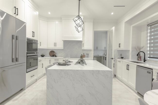 Kitchen featuring appliances with stainless steel finishes, a sink, a kitchen island, tasteful backsplash, and recessed lighting | Image 8