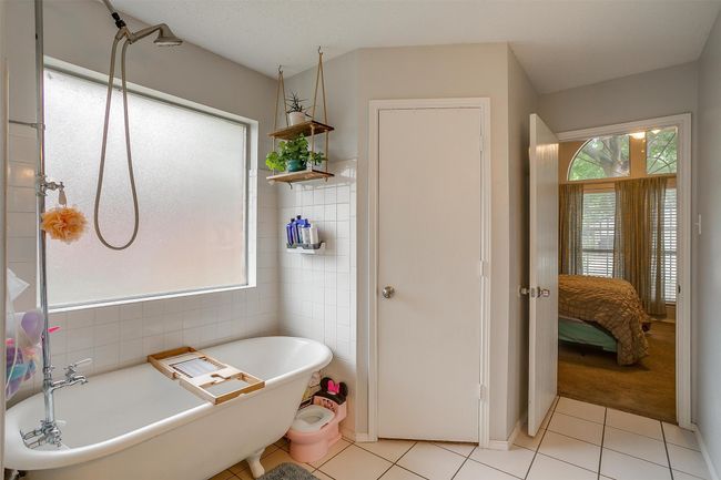 Ensuite bathroom featuring tile patterned flooring, a freestanding tub, and tile walls | Image 29