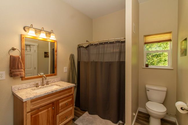 Full bath with heating unit, vanity, and baseboards | Image 12