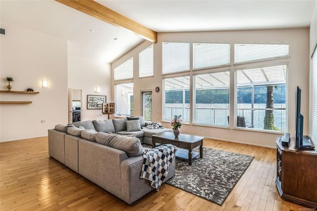 Living room with beam ceiling, light wood finished floors, and high vaulted ceiling | Image 21