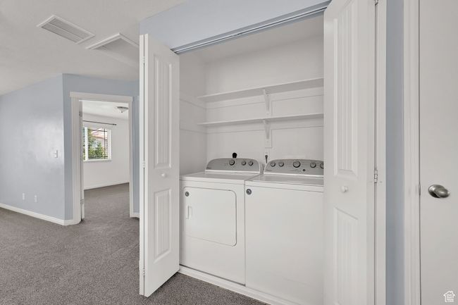 Laundry room featuring separate washer and dryer and carpet floors | Image 19