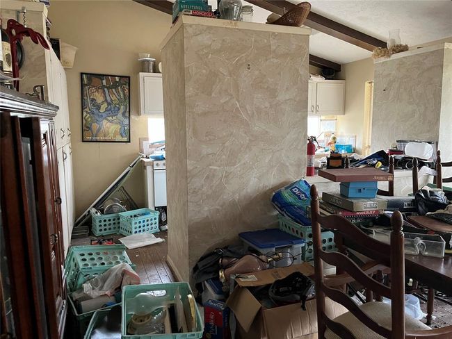 The kitchen is beyond the dining room. | Image 35