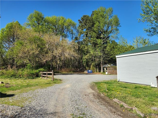 Ample parking in the rear of the building. Graveled drive and parking area. | Image 7