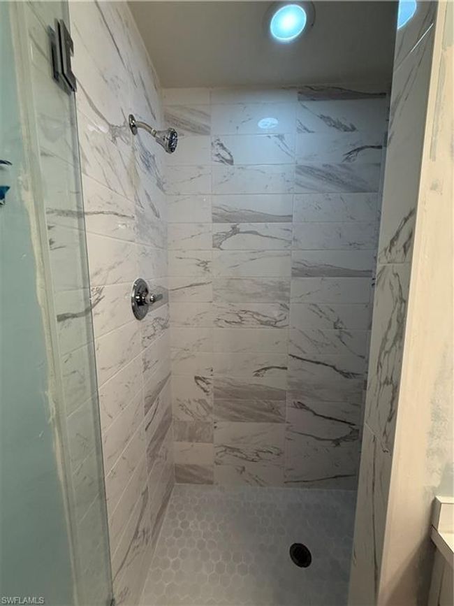 Bathroom featuring a glass enclosed shower stall and recessed lighting | Image 16