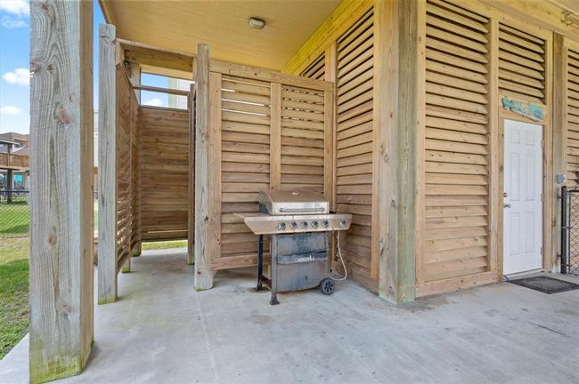 Side garage entrance and a sand shower on the back side of the garage | Image 43