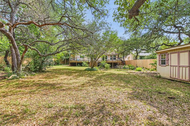 View of yard with an outdoor structure, fence, and a wooden deck | Image 23