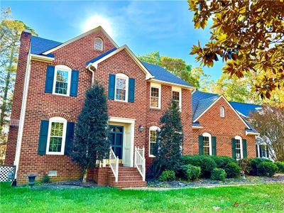 Colonial house featuring a front lawn | Image 1