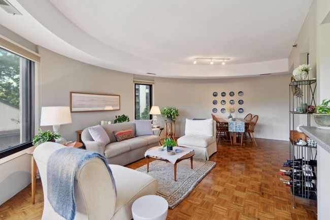 Spacious living room with an abundance of natural light and plenty of space for hosting friends and family. | Image 4