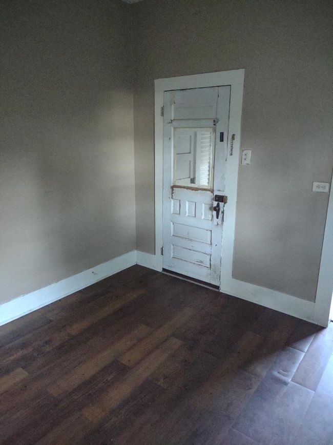 Empty room featuring dark wood-type flooring and baseboards | Image 23