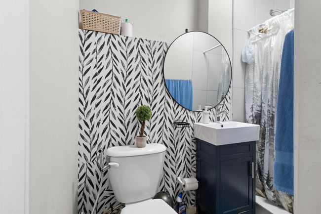 Bathroom featuring vanity, toilet, and a shower with shower curtain | Image 29