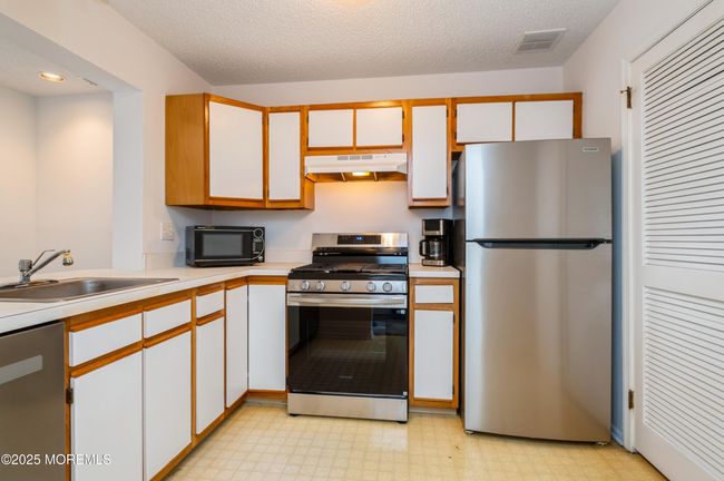 Kitchen with all new stainless steel appliances | Image 11