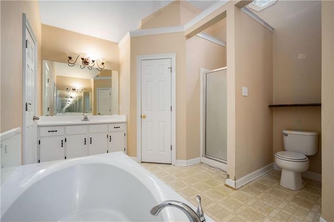 Full bath featuring vanity, a stall shower, a garden tub, and tile patterned floors | Image 18
