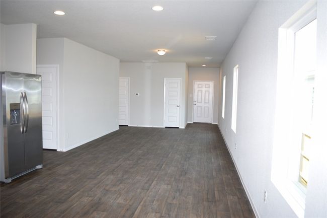 Unfurnished living room with recessed lighting and dark wood-style floors | Image 8