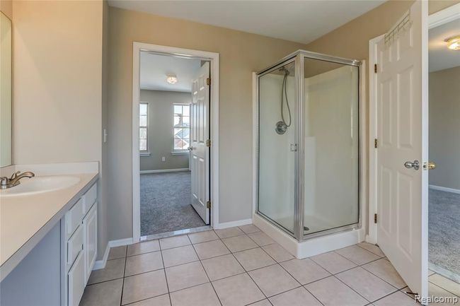 Jack and Jill bath with ceramic floors and stand up shower. | Image 15