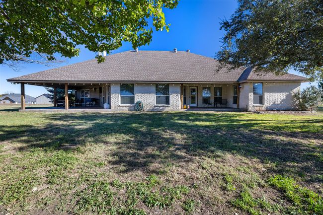 Back of property with brick siding, a patio area, and a lawn | Image 26