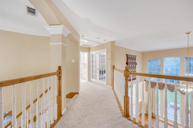 Hall featuring an upstairs landing, crown molding, and carpet floors | Image 37