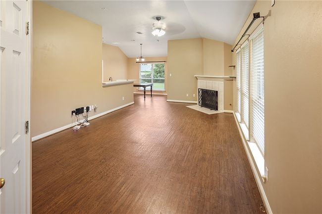 Vinyl plank floor with corner fireplace. | Image 4