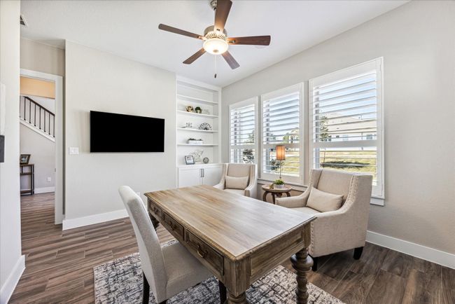 Handsome Study/ Home Office has a custom built in book case & cabinets for storage. | Image 7
