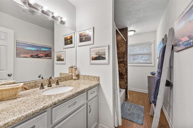 Well-appointed guest bathroom featuring modern fixtures and a tub-shower combo. | Image 9