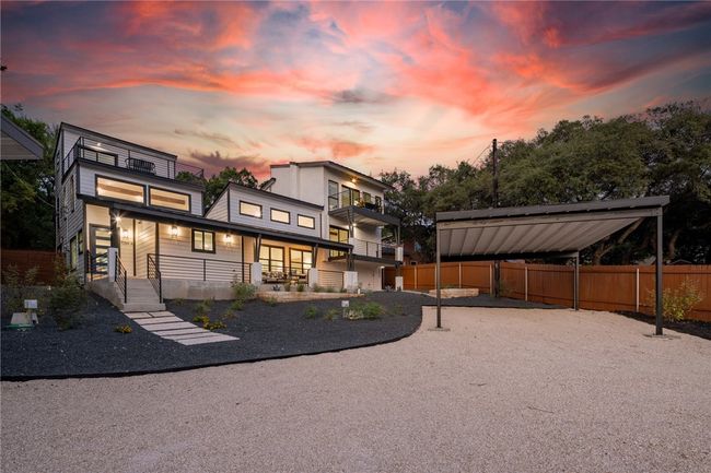 The home offers irresistible curb appeal with gorgeous black-framed windows, professional xeriscape landscaping, and a welcoming covered front porch. | Image 37