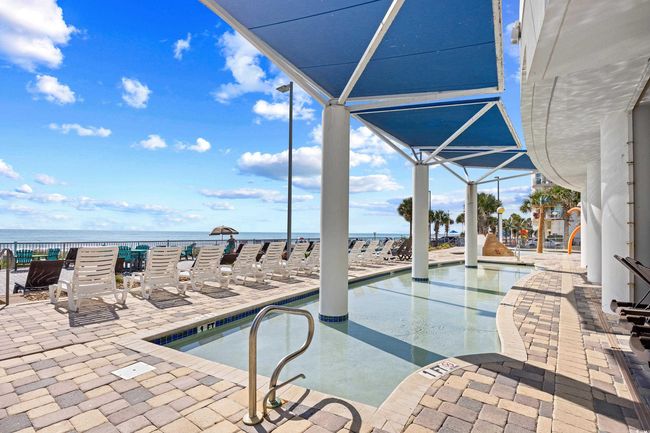 View of swimming pool featuring a patio and a water view | Image 32