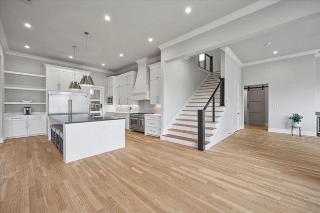 Kitchen stairway leads to 2nd living area | Image 12