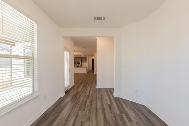 Corridor featuring visible vents, dark wood-style flooring, and baseboards | Image 6