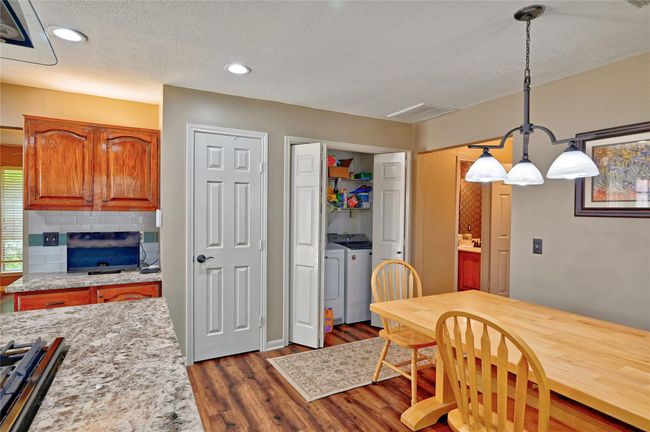 Convenient indoor laundry located next to a spacious pantry. | Image 16