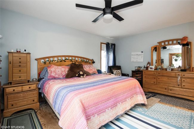 Bedroom featuring ceiling fan and wood finished floors | Image 15