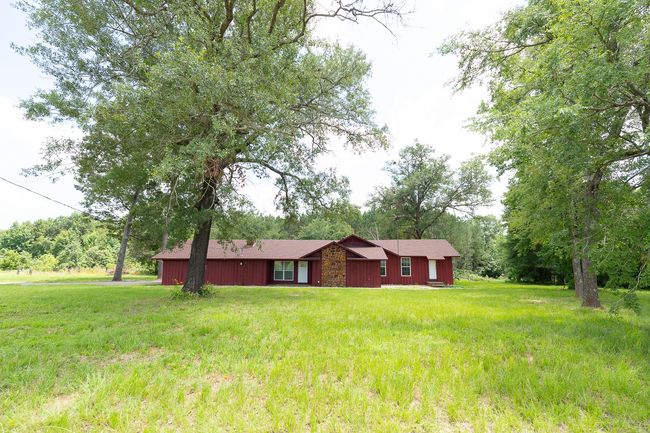 Ranch-style home featuring a front lawn and roof with shingles | Image 6
