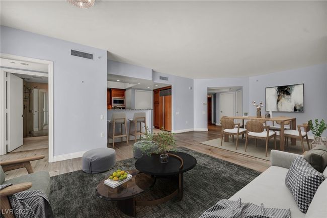Virtually Staged Living room featuring baseboards, visible vents, and light wood-type flooring | Image 9