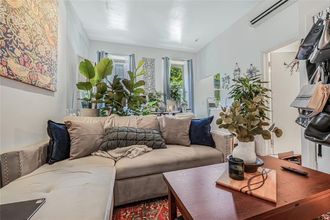 Living room featuring an AC wall unit | Image 8