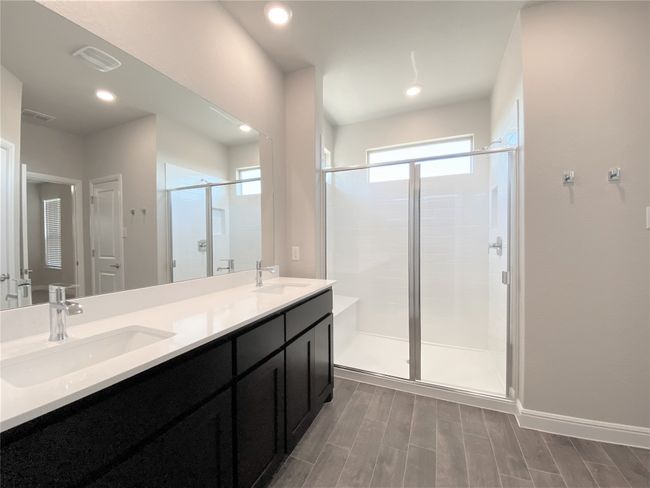 Full bathroom with a stall shower, double vanity, wood finished floors, and recessed lighting | Image 6