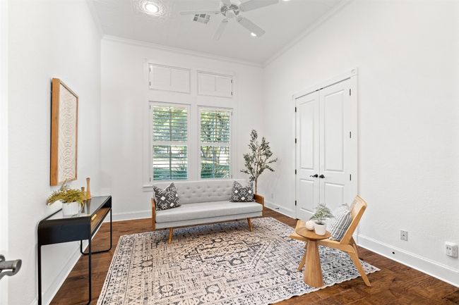 Sitting room with ornamental molding, ceiling fan, wood finished floors, and baseboards | Image 20