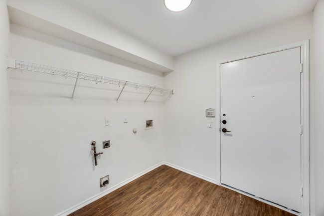 Washroom featuring hookup for an electric dryer, gas dryer hookup, dark wood-type flooring, baseboards, and washer hookup | Image 20